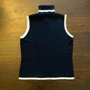 Sleeveless black and white knit turtleneck.